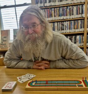 Photo of Peter Beckford with Cribbage board in foreground